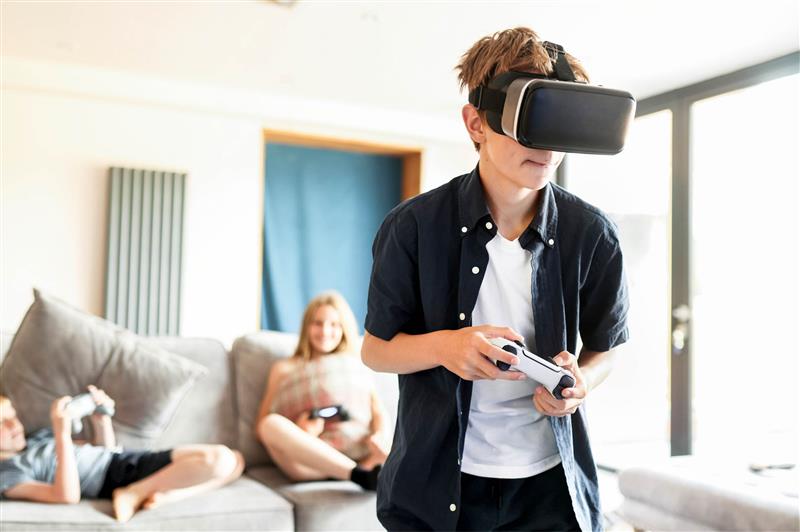 Teenager playing with electrical VR headset
